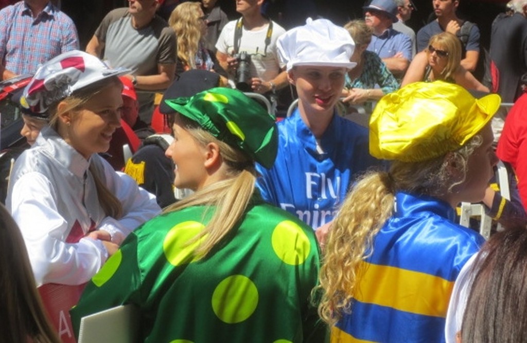 three young women in racing clothes